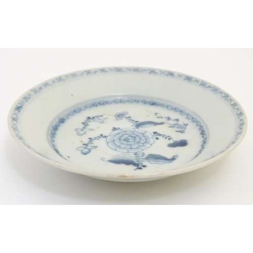 62 - An 18thC Chinese blue and white plate, with hand painted floral decoration. Bears 'Nagel Auctions Te... 