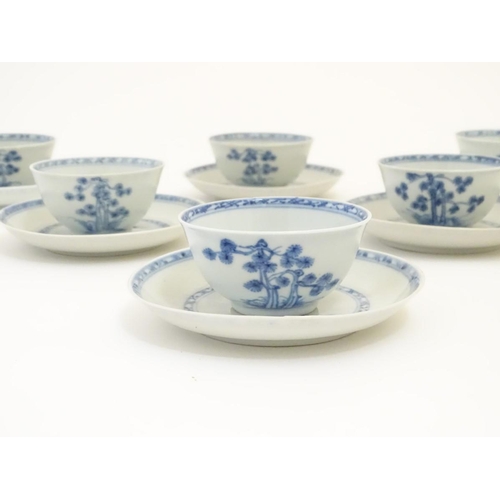 63 - A set of six 18thC Chinese Nanking Cargo blue and white tea bowls and saucers, decorated with pine t... 