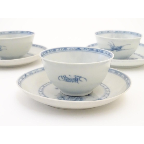 63 - A set of six 18thC Chinese Nanking Cargo blue and white tea bowls and saucers, decorated with pine t... 