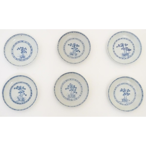 63 - A set of six 18thC Chinese Nanking Cargo blue and white tea bowls and saucers, decorated with pine t... 