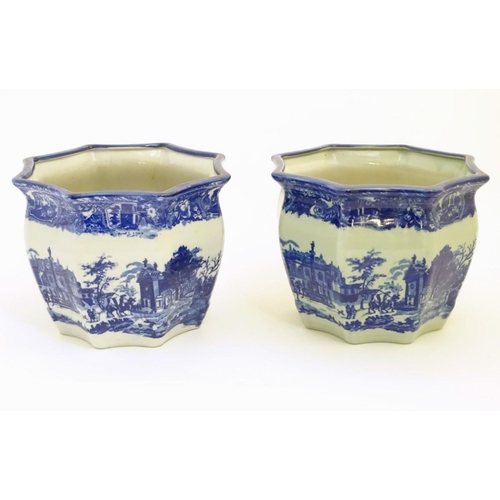 64 - A pair of Masons style blue and white octagonal jardinieres depicting an urban scene with buildings,... 