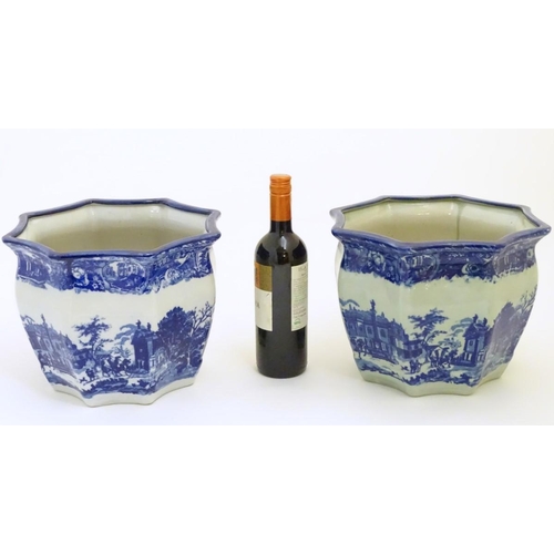 64 - A pair of Masons style blue and white octagonal jardinieres depicting an urban scene with buildings,... 