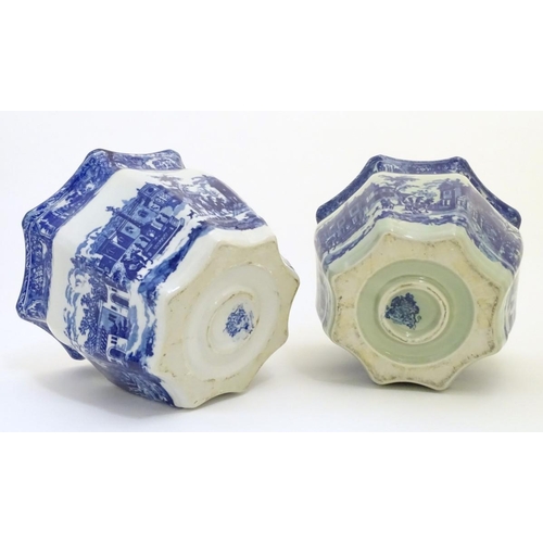 64 - A pair of Masons style blue and white octagonal jardinieres depicting an urban scene with buildings,... 