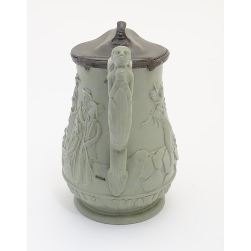 69 - A stoneware pitcher with hinged lid by E. Ridway & Abington, with moulded relief decoration of anti-... 