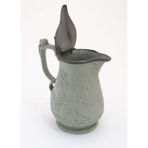 69 - A stoneware pitcher with hinged lid by E. Ridway & Abington, with moulded relief decoration of anti-... 