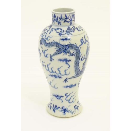 7 - A Chinese blue and white vase with stylised dragon and cloud decoration and floral borders. Characte... 