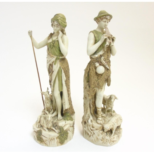 75 - A pair of early 20thC Royal Dux Bohemia figures comprising a shepherd playing the flute and a shephe... 