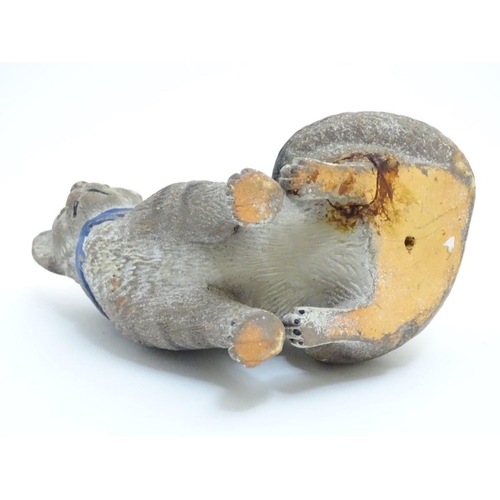 77 - A ceramic model of a seated cat with large ears and a blue bow collar. Approx. 6 ¾'' high.