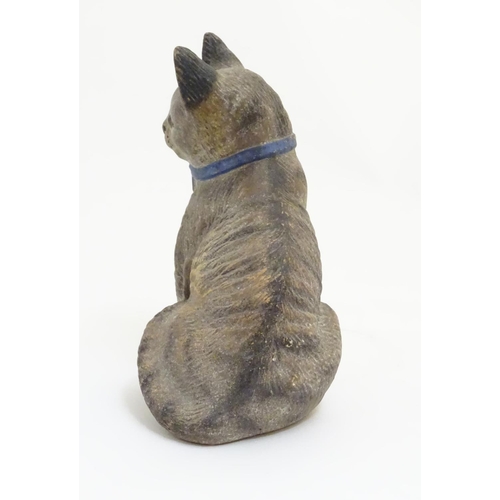 77 - A ceramic model of a seated cat with large ears and a blue bow collar. Approx. 6 ¾'' high.