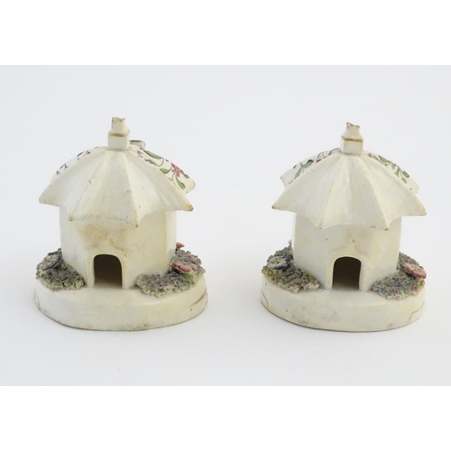 80 - A pair of Staffordshire pottery pastille burners in the form of cottages, decorated with flowers. Ap... 