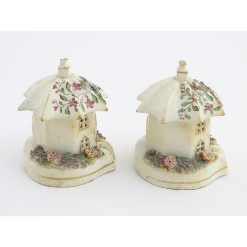 80 - A pair of Staffordshire pottery pastille burners in the form of cottages, decorated with flowers. Ap... 