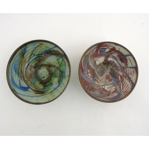 86 - Two 20thC Alan Ward studio pottery bowls, one decorated with blue and brown trail detail on a pale b... 