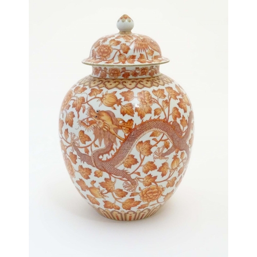 8 - A Chinese orange and white lidded ginger jar decorated with dragons, phoenix birds and scrolling flo... 