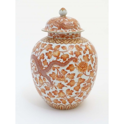 8 - A Chinese orange and white lidded ginger jar decorated with dragons, phoenix birds and scrolling flo... 