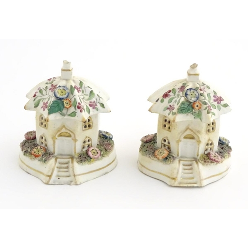 80 - A pair of Staffordshire pottery pastille burners in the form of cottages, decorated with flowers. Ap... 