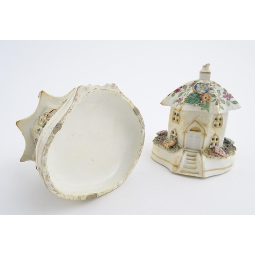 80 - A pair of Staffordshire pottery pastille burners in the form of cottages, decorated with flowers. Ap... 