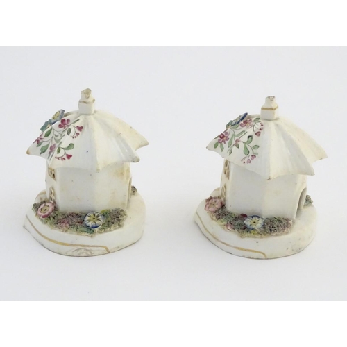 80 - A pair of Staffordshire pottery pastille burners in the form of cottages, decorated with flowers. Ap... 