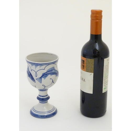 93 - A Laurence McGowan British studio pottery goblet with blue hand painted fish decoration. Monogram an... 