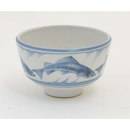 94 - A Laurence McGowan British studio pottery footed bowl, with blue hand painted fish decoration. Monog... 