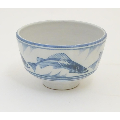 94 - A Laurence McGowan British studio pottery footed bowl, with blue hand painted fish decoration. Monog... 