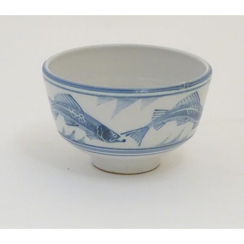 94 - A Laurence McGowan British studio pottery footed bowl, with blue hand painted fish decoration. Monog... 