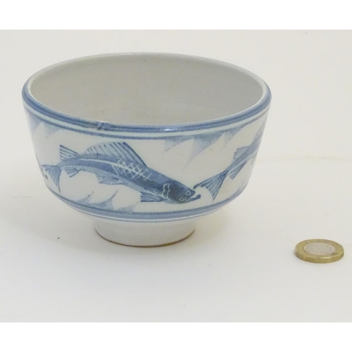 94 - A Laurence McGowan British studio pottery footed bowl, with blue hand painted fish decoration. Monog... 