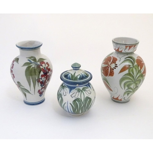 96 - Three items of Laurence McGowan British studio pottery, to include a vase with hand painted lily dec... 