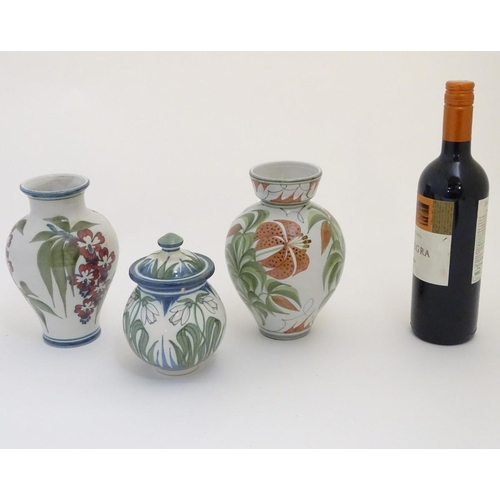 96 - Three items of Laurence McGowan British studio pottery, to include a vase with hand painted lily dec... 