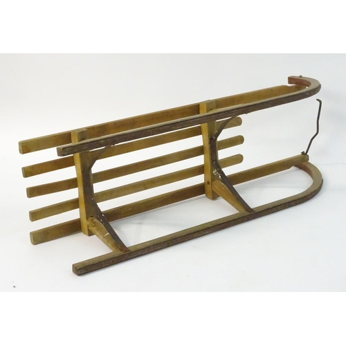 110 - A mid 20thC traditional sledge with high slatted wooden seat and metal runners etc., approximately 1... 