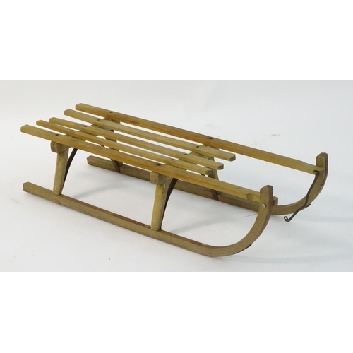 110 - A mid 20thC traditional sledge with high slatted wooden seat and metal runners etc., approximately 1... 