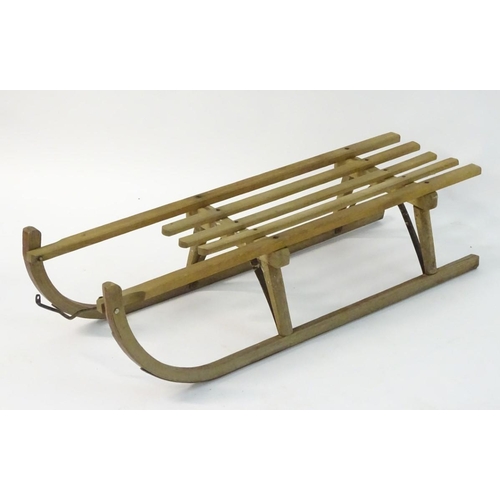 110 - A mid 20thC traditional sledge with high slatted wooden seat and metal runners etc., approximately 1... 