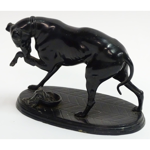 75 - A painted Spelter figure of a dog on an oval base, 6 1/2'' long