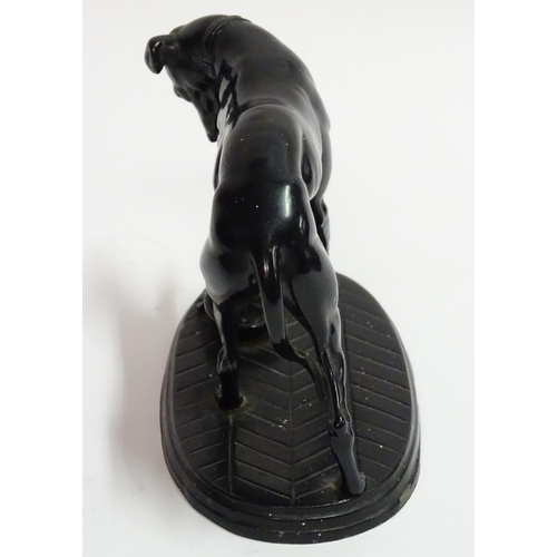 75 - A painted Spelter figure of a dog on an oval base, 6 1/2'' long