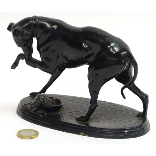 75 - A painted Spelter figure of a dog on an oval base, 6 1/2'' long