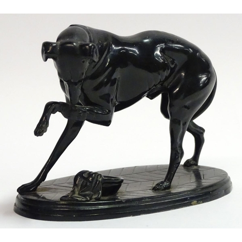 75 - A painted Spelter figure of a dog on an oval base, 6 1/2'' long