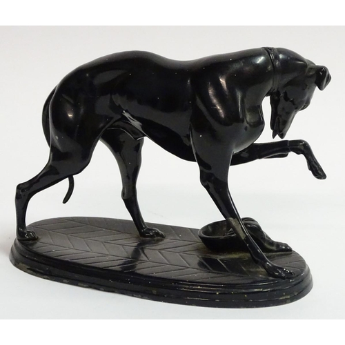 75 - A painted Spelter figure of a dog on an oval base, 6 1/2'' long