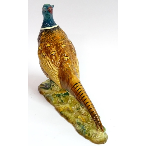 77 - Beswick: a hand painted ceramic pheasant, no 1225, standing 7 1/2'' high.