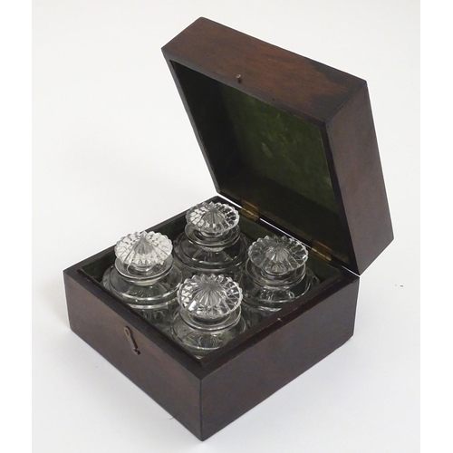 119 - A set of four 19thC glass scent bottles and stoppers with cut decoration within a wooden box. Each s... 