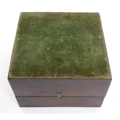 119 - A set of four 19thC glass scent bottles and stoppers with cut decoration within a wooden box. Each s... 