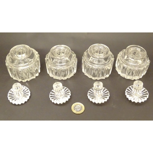 119 - A set of four 19thC glass scent bottles and stoppers with cut decoration within a wooden box. Each s... 