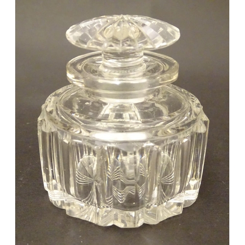 119 - A set of four 19thC glass scent bottles and stoppers with cut decoration within a wooden box. Each s... 