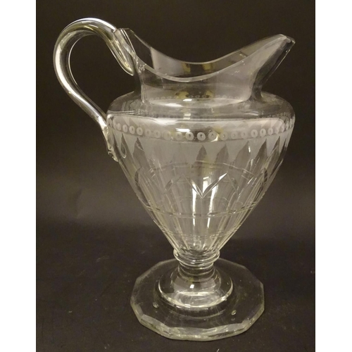 146 - An Irish glass water jug c.1800, together with a 19thC cut glass cream jug. Tallest approx. 9'' high... 