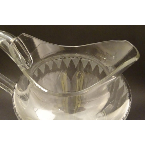 146 - An Irish glass water jug c.1800, together with a 19thC cut glass cream jug. Tallest approx. 9'' high... 
