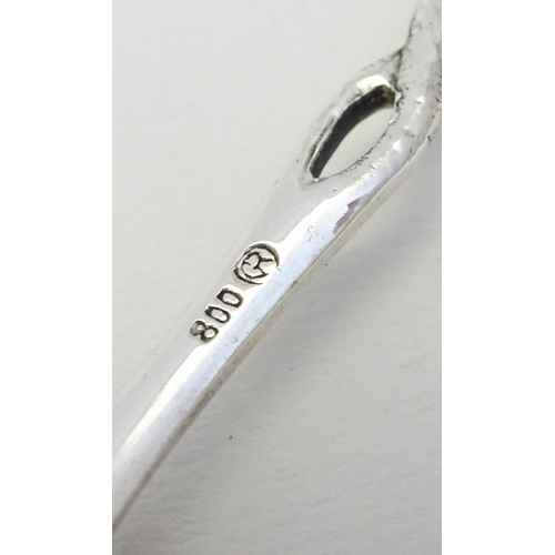 184 - A .800 German silver butter knife with rose decoration to handle together with a teaspoon hallmarked... 