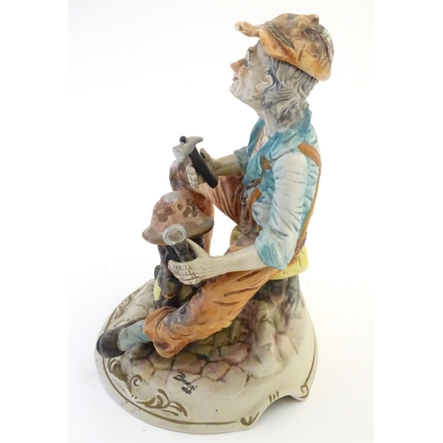 63 - A Capodimonte figure of an elderly man with tools, possibly an armourer. Indistinctly signed to base... 