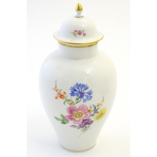 72 - A Continental lidded vase with hand painted floral decoration. Meissen style marks under. Approx. 9 ... 