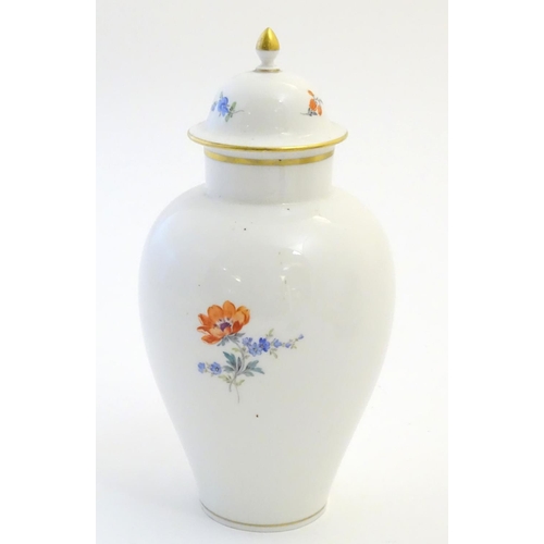 72 - A Continental lidded vase with hand painted floral decoration. Meissen style marks under. Approx. 9 ... 