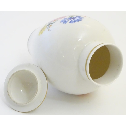 72 - A Continental lidded vase with hand painted floral decoration. Meissen style marks under. Approx. 9 ... 