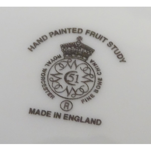 77 - A Royal Worcester plate with hand painted decoration depicting a study of a still life of fruit, app... 