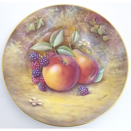 77 - A Royal Worcester plate with hand painted decoration depicting a study of a still life of fruit, app... 